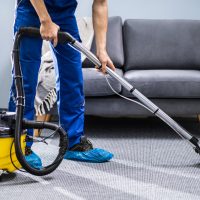 Photo,Of,Janitor,Cleaning,Carpet,With,Vacuum,Cleaner