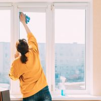 Woman,Of,Fifty,In,Yellow,Sweater,And,Jeans,Washes,Dusty